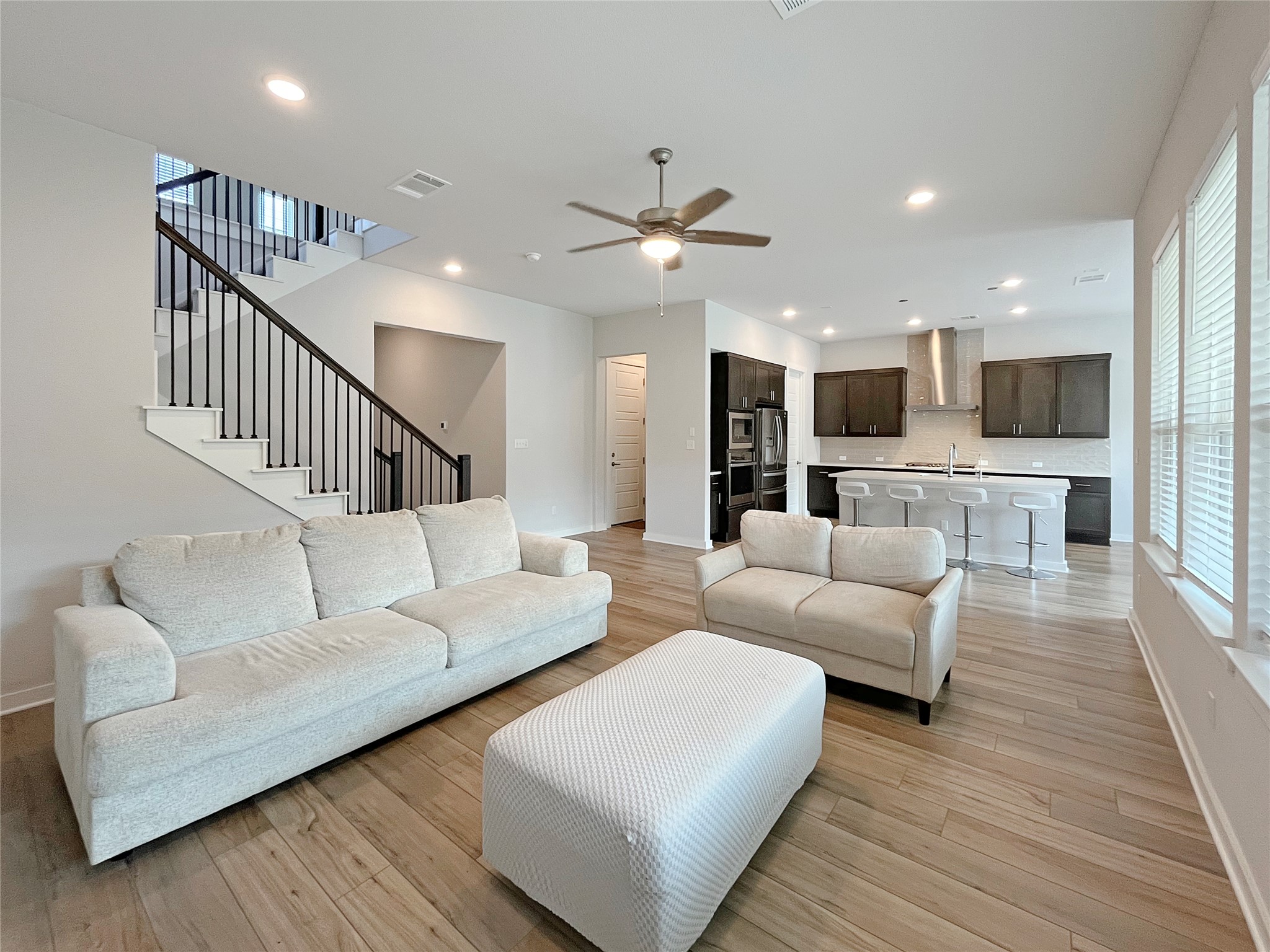 1200 Willie Rnch Way Leander, TX 78641 - Photo 4 of 25 Living room with stairway, ceiling fan, light wood-type flooring, and recessed lighting
