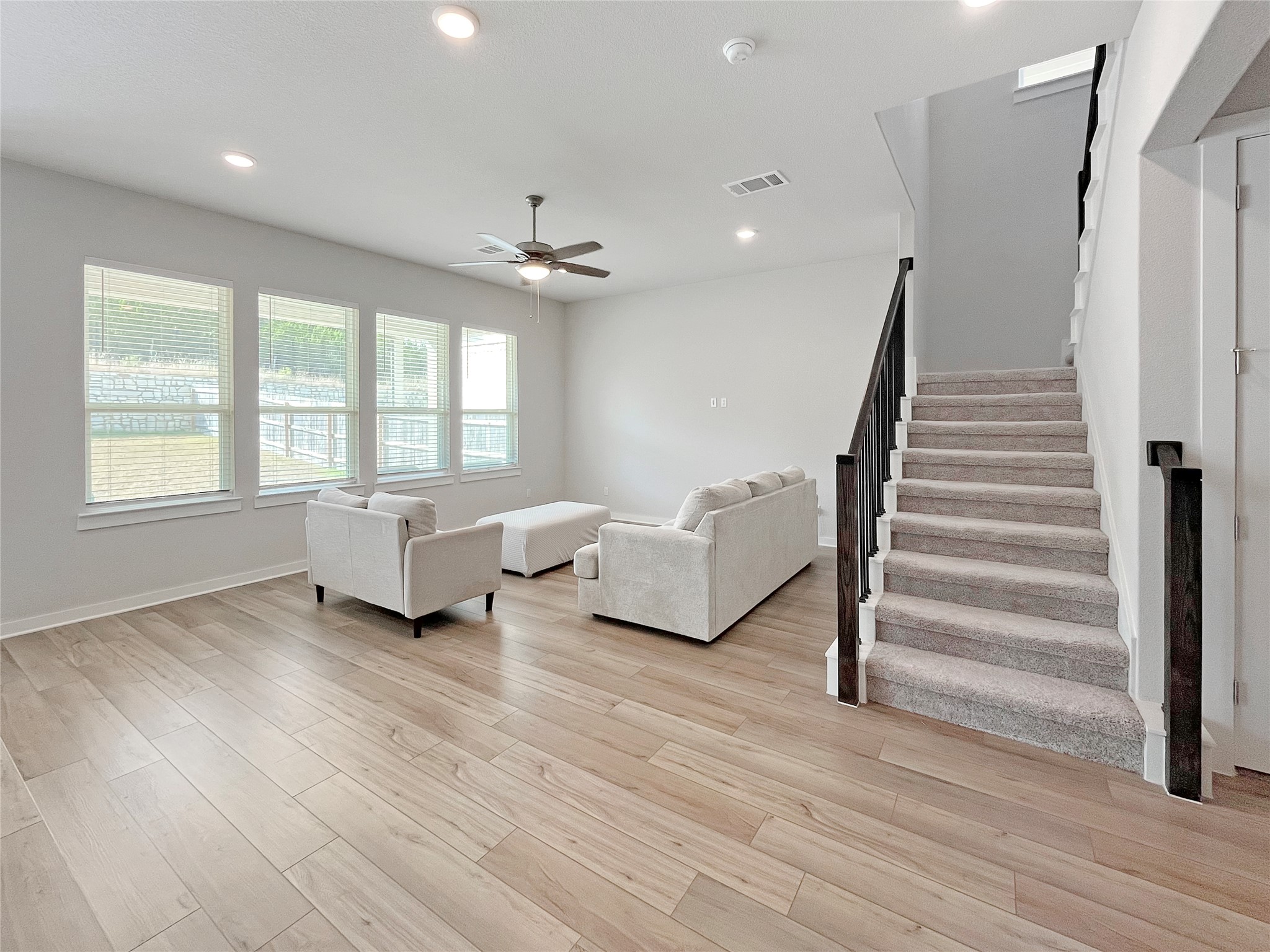 1200 Willie Rnch Way Leander, TX 78641 - Photo 5 of 25 Living room with stairway, recessed lighting, a ceiling fan, and light wood-type flooring