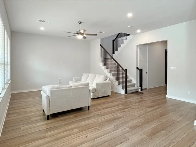 a living room with furniture and kitchen