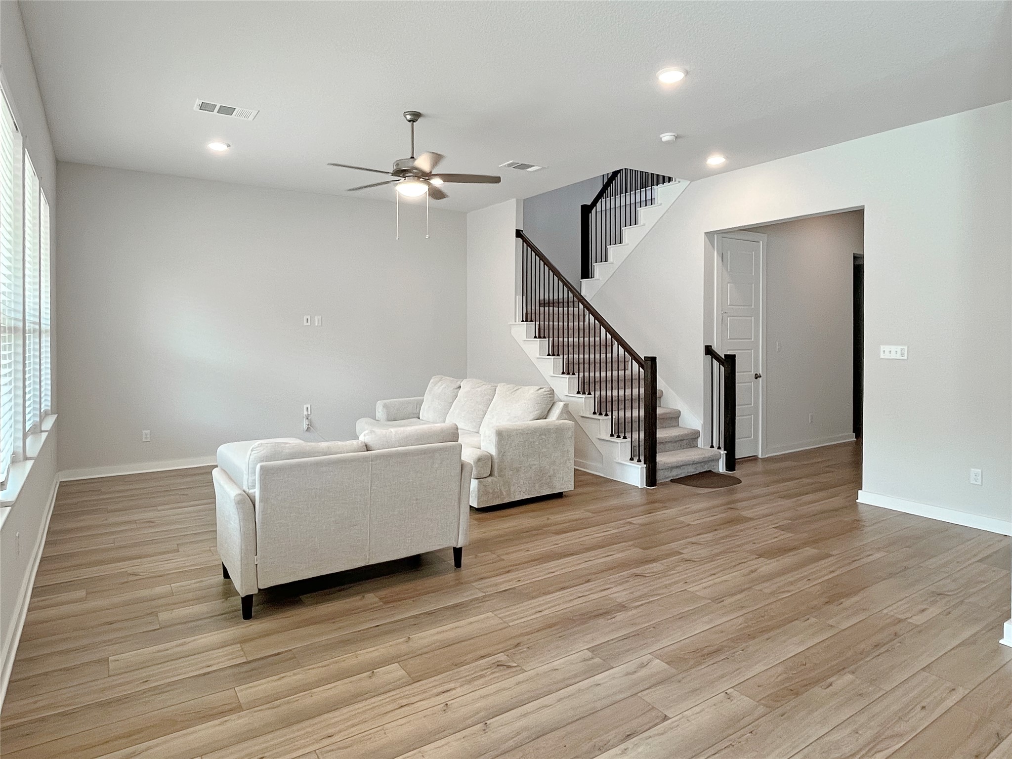 1200 Willie Rnch Way Leander, TX 78641 - Photo 7 of 25 Living room featuring stairs, light wood-style flooring, recessed lighting, and a ceiling fan