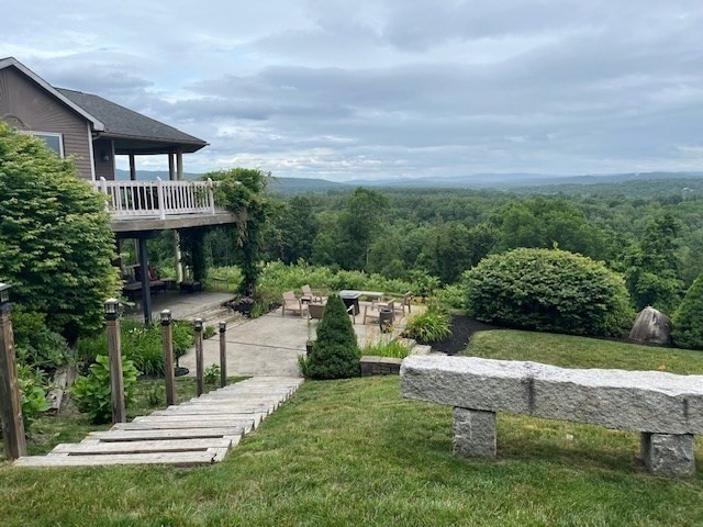 151 Smead Hill Road Greenfield, MA 01301 - Photo 1 of 13 a view of a garden with lawn chairs plants and large tree
