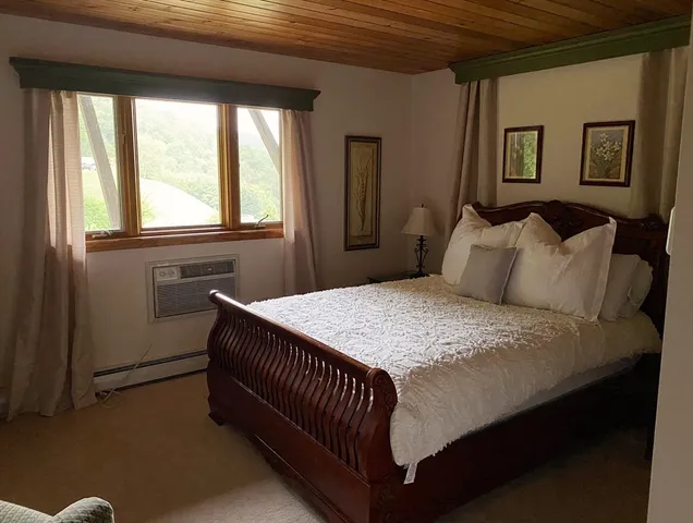 a bedroom with a bed and window