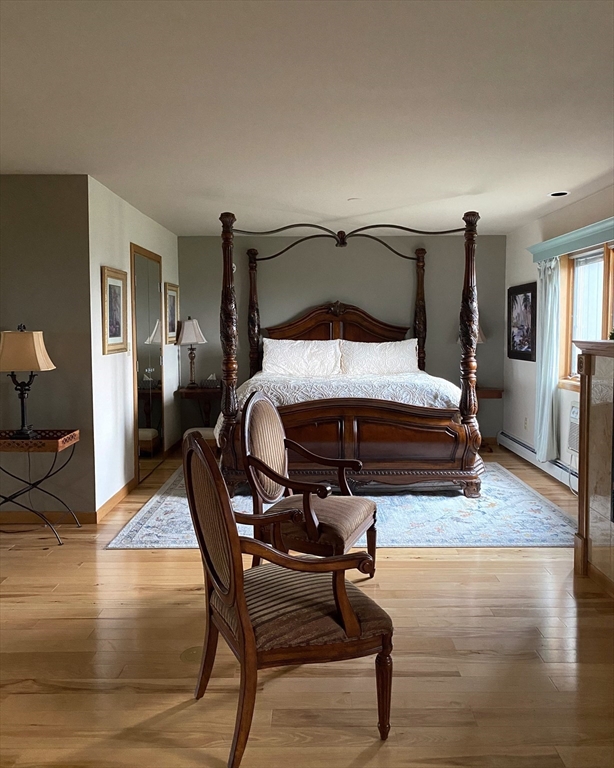 151 Smead Hill Road Greenfield, MA 01301 - Photo 13 of 24 a bedroom with furniture and wooden floor