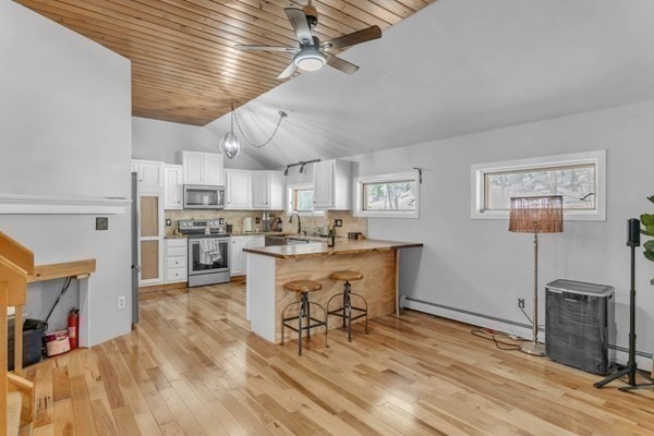 151 Smead Hill Road Greenfield, MA 01301 - Photo 13 of 13 a kitchen with cabinets and wooden floor