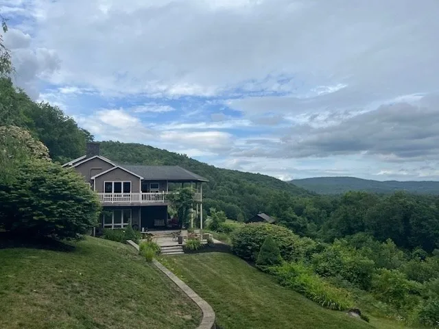 an aerial view of a house with swimming pool and garden