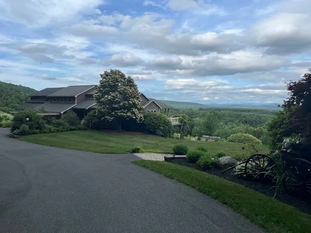 a view of a city street next to a yard