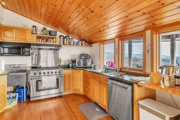 a kitchen with stainless steel appliances granite countertop a stove and a sink