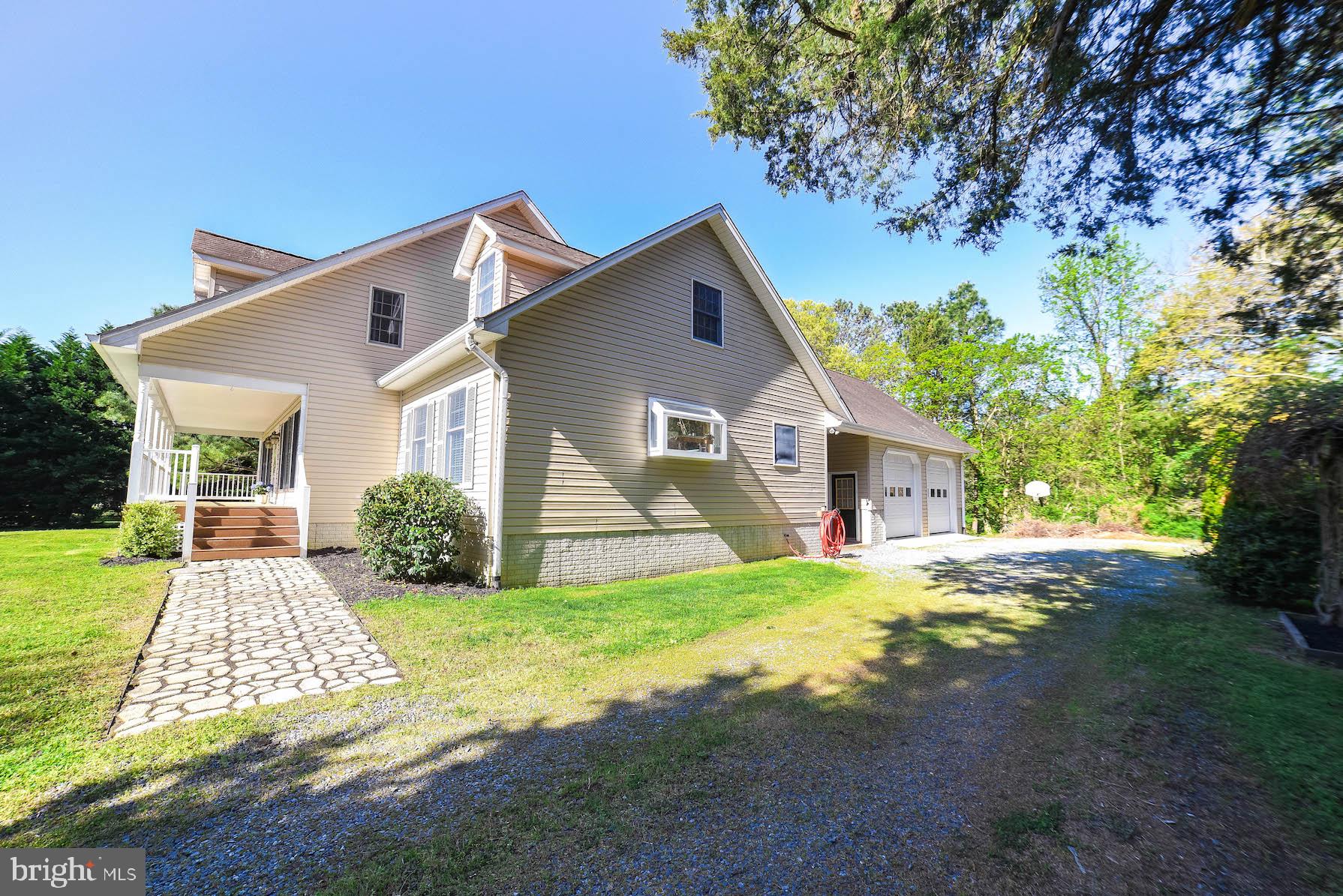 13425 Olivet Road Lusby, MD 20657 - Photo 14 of 59 a front view of a house with a yard and garage