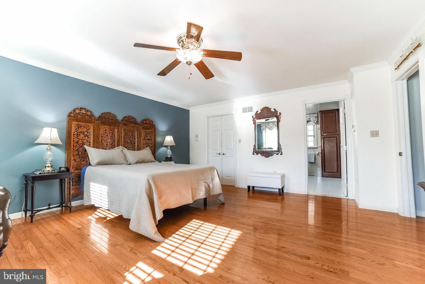 13425 Olivet Road Lusby, MD 20657 - Photo 26 of 59 a bedroom with a bed and wooden floor