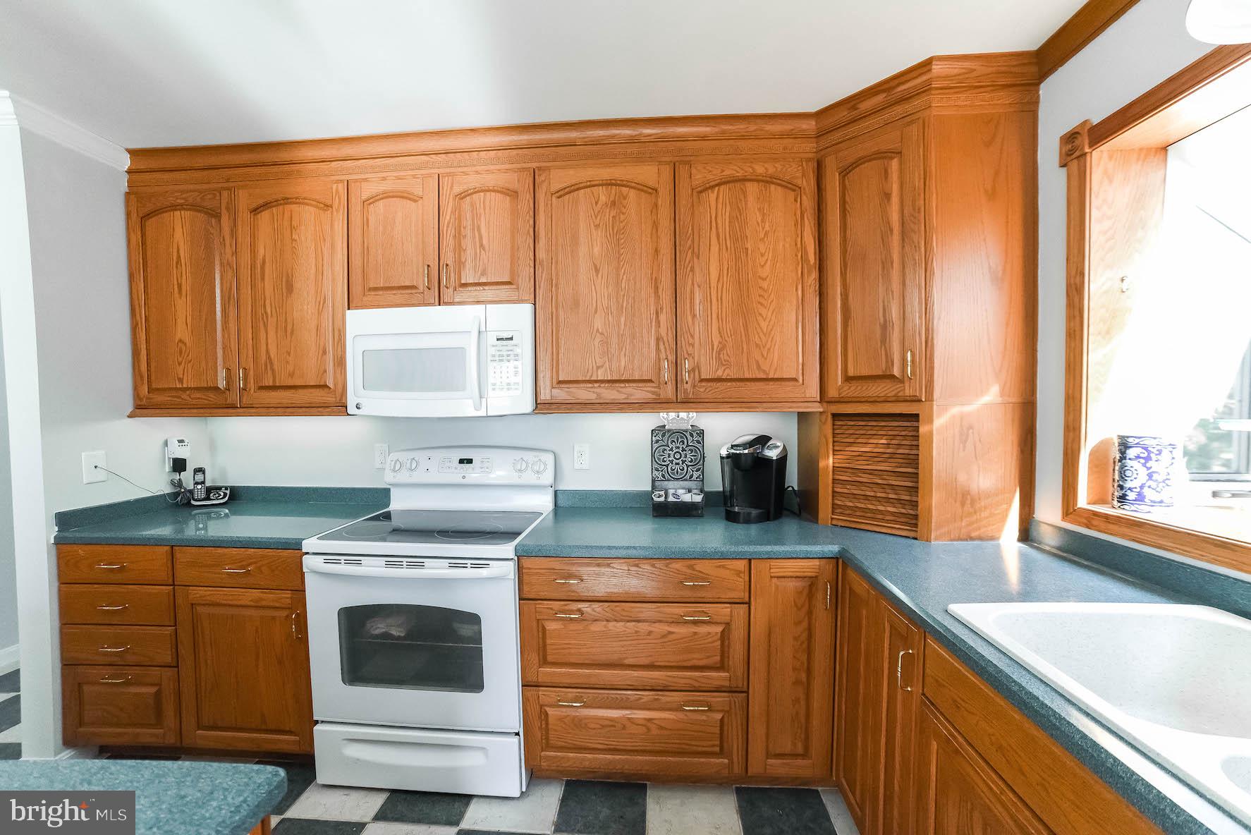 13425 Olivet Road Lusby, MD 20657 - Photo 37 of 59 a kitchen with stainless steel appliances granite countertop a sink a stove and cabinets
