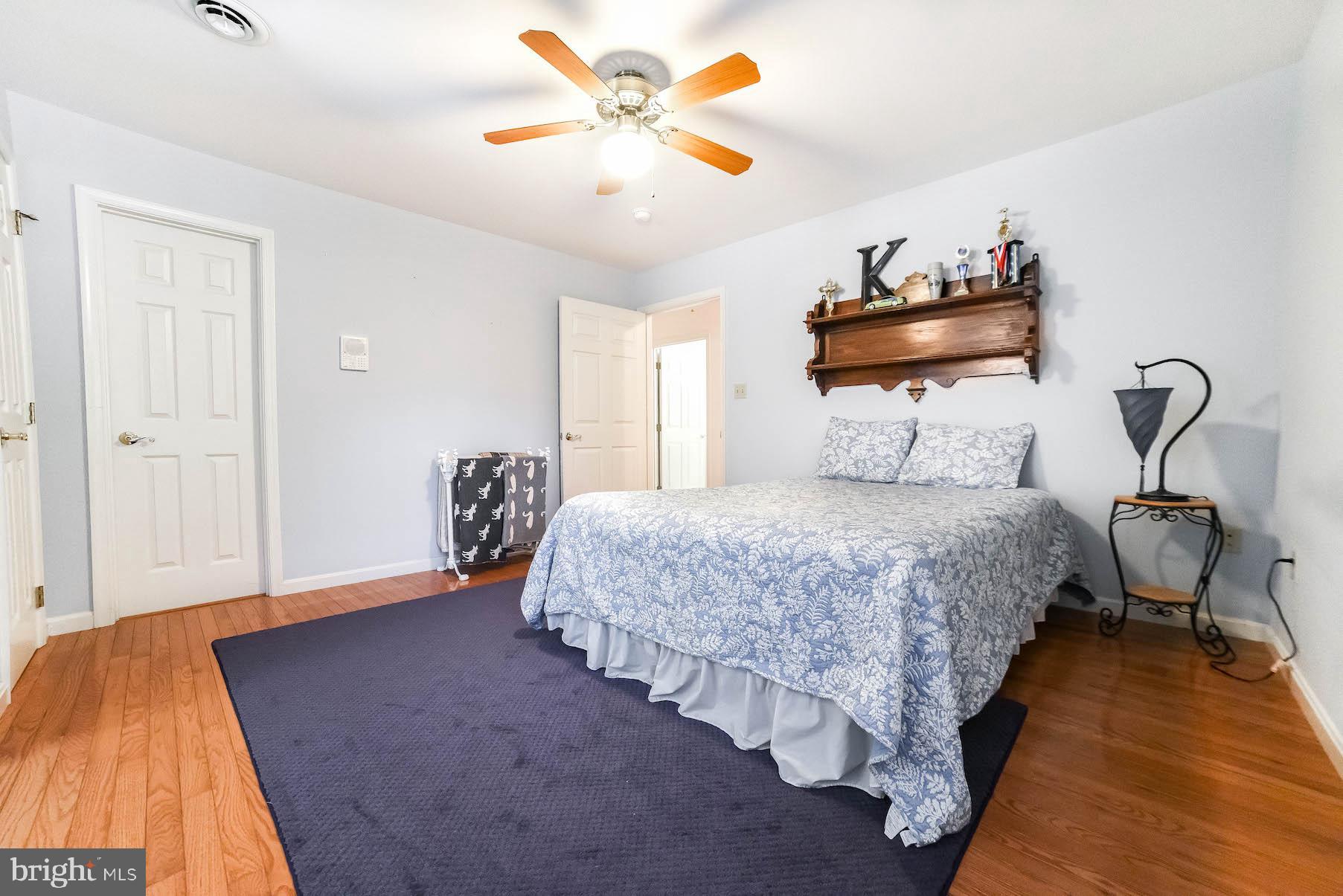 13425 Olivet Road Lusby, MD 20657 - Photo 49 of 59 a bedroom with a bed and a chandelier