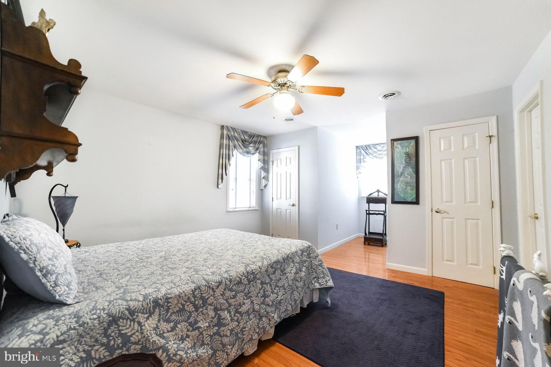 13425 Olivet Road Lusby, MD 20657 - Photo 50 of 59 a bedroom with a bed and a chandelier