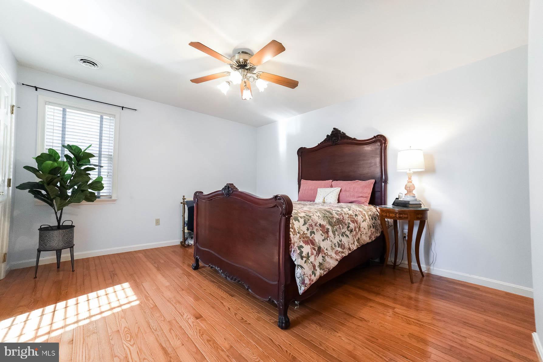 13425 Olivet Road Lusby, MD 20657 - Photo 51 of 59 a bedroom with a bed and wooden floor