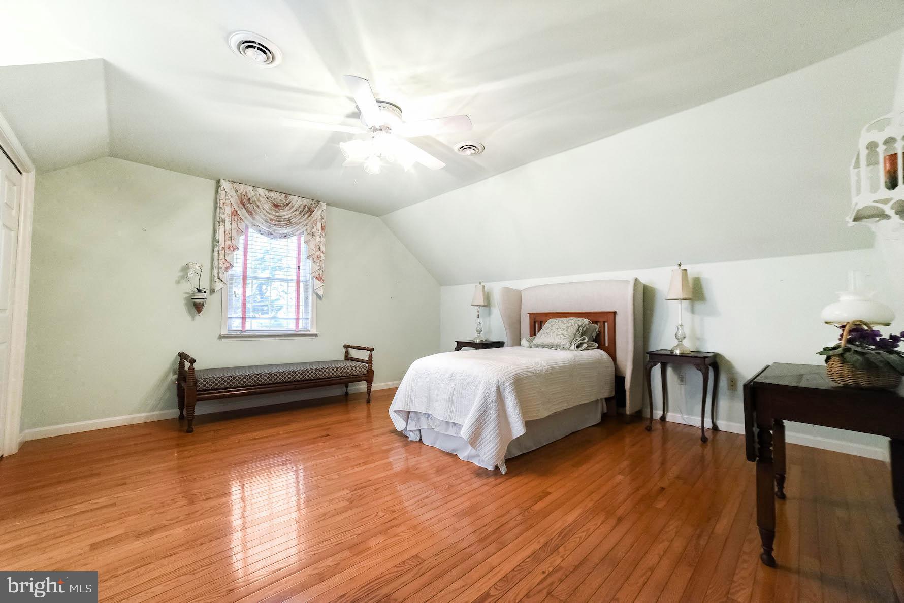 13425 Olivet Road Lusby, MD 20657 - Photo 54 of 59 a bedroom with a bed and wooden floor