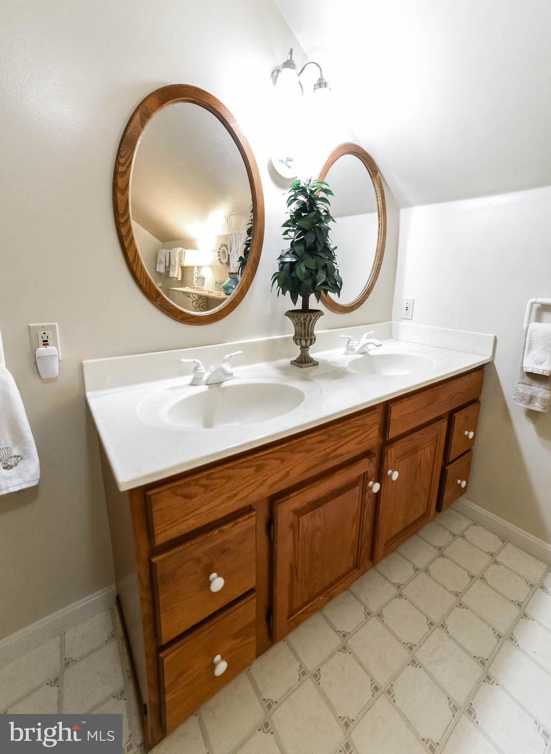 13425 Olivet Road Lusby, MD 20657 - Photo 56 of 59 a bathroom with a sink a mirror and a light fixture