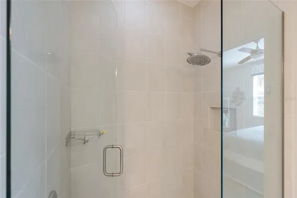 a bathroom with a glass shower door