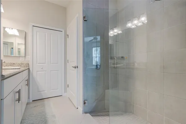 a bathroom with a shower and a sink