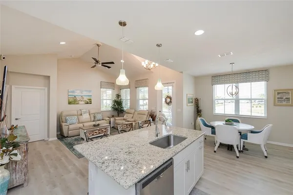 a kitchen with stainless steel appliances kitchen island granite countertop a refrigerator and microwave