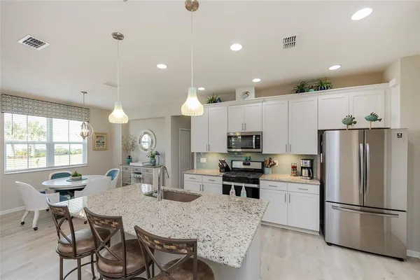 a kitchen with kitchen island appliances cabinets and furniture