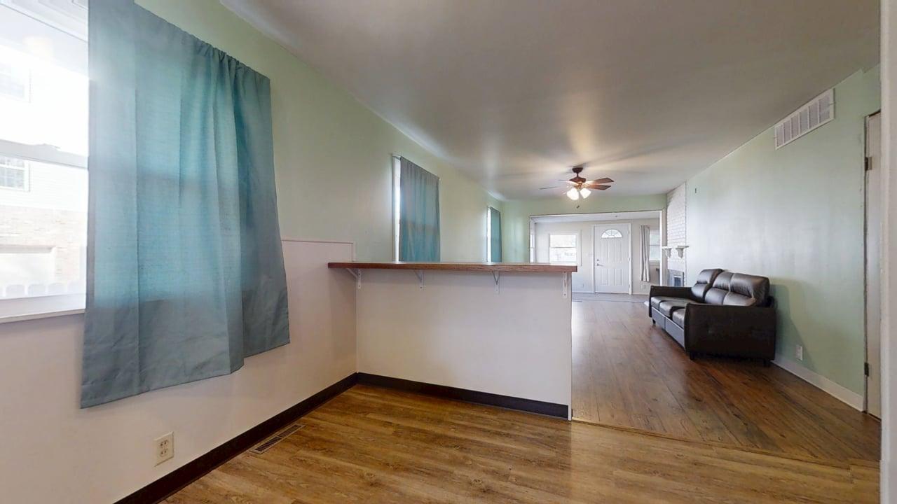 915 Morgan Street Normal, IL 61761 - Photo 14 of 43 a view of a living room a kitchen with furniture and wooden floor