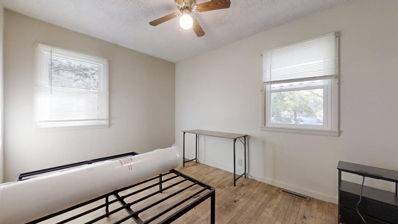 915 Morgan Street Normal, IL 61761 - Photo 15 of 43 a view of an empty room with a window and wooden floor