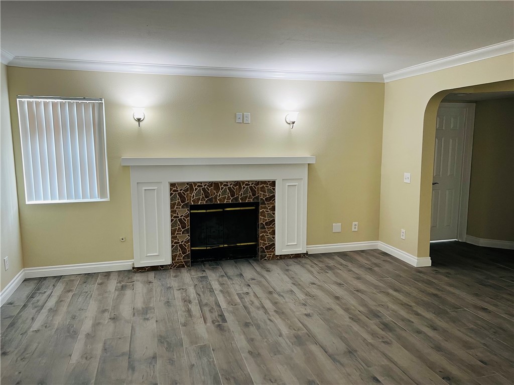 12771 Ponderosa Ranch Road Victorville, CA 92392 - Photo 13 of 23 an empty room with wooden floor and fireplace