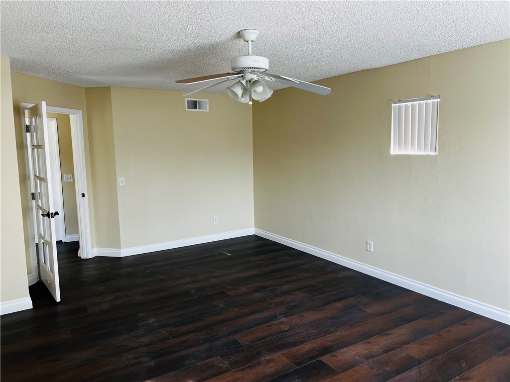 12771 Ponderosa Ranch Road Victorville, CA 92392 - Photo 17 of 23 a view of a room with wooden floor and chandelier