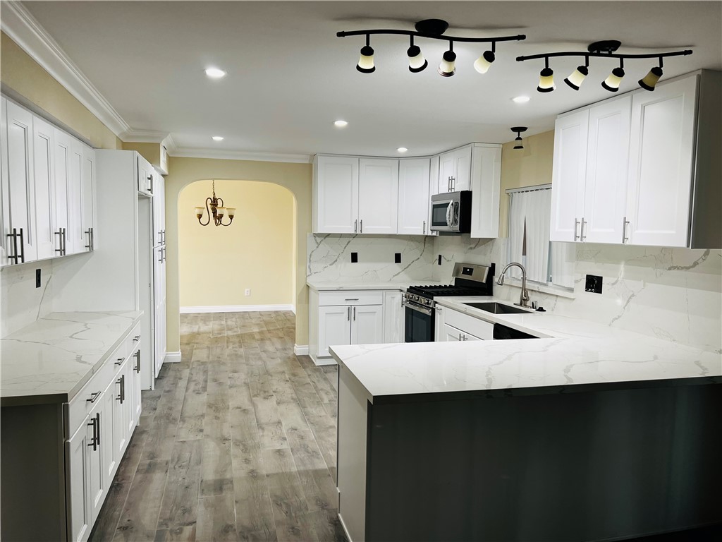 12771 Ponderosa Ranch Road Victorville, CA 92392 - Photo 3 of 23 a kitchen with stainless steel appliances a sink stove and refrigerator