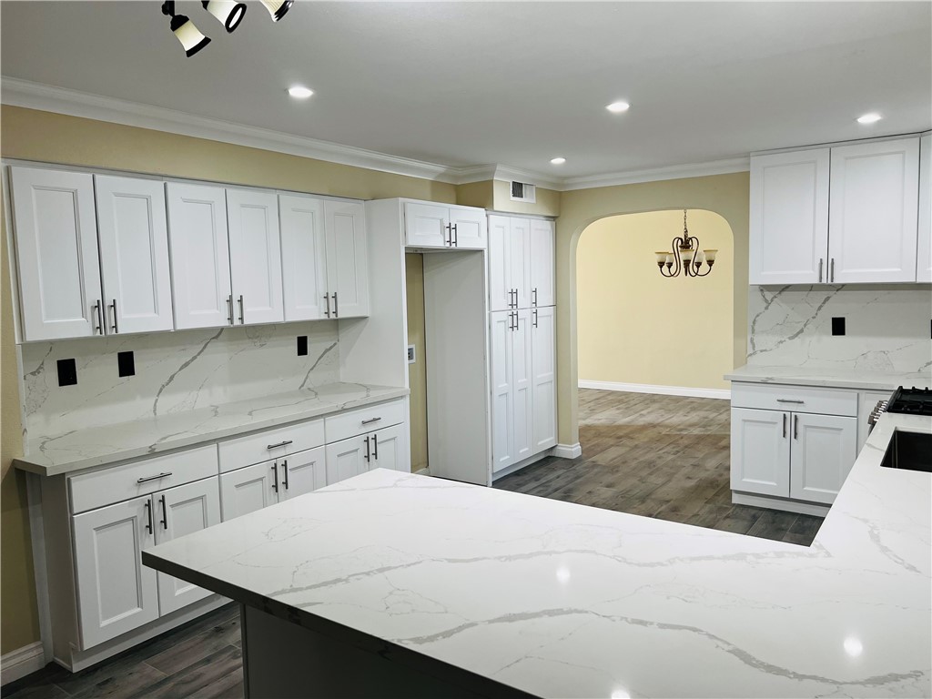 12771 Ponderosa Ranch Road Victorville, CA 92392 - Photo 4 of 23 a kitchen with stainless steel appliances a refrigerator sink and cabinets
