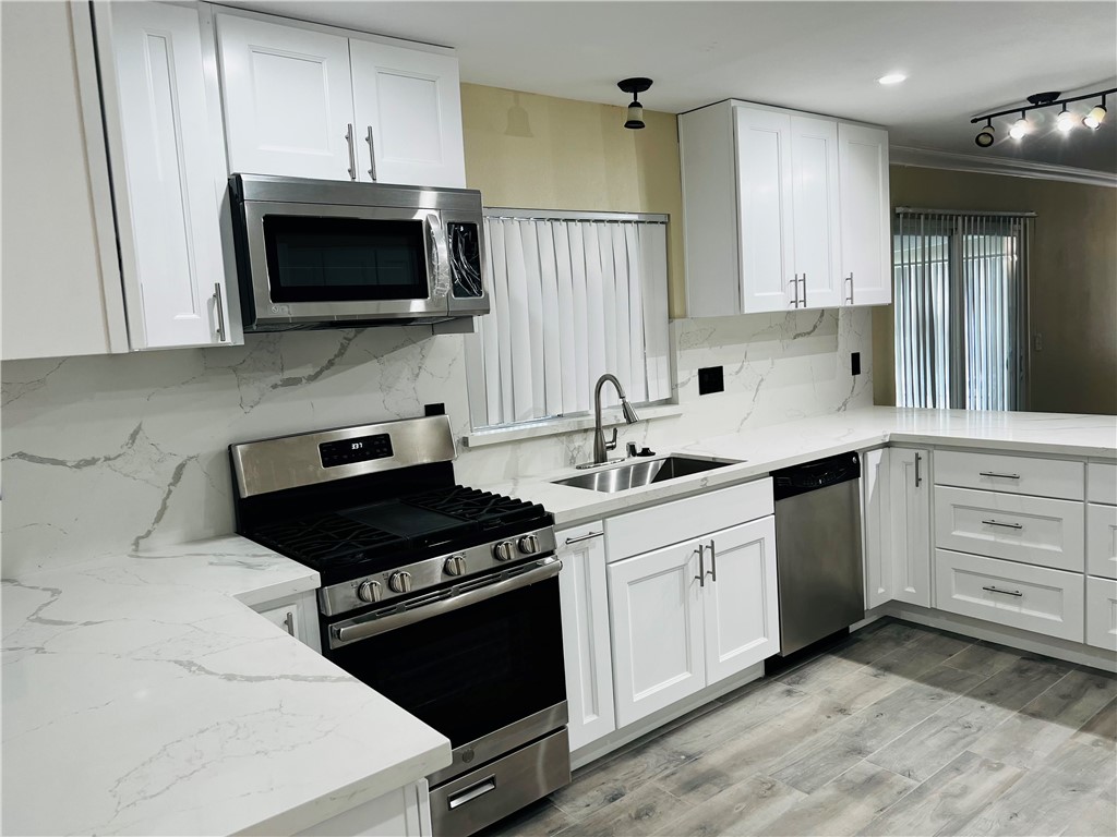 12771 Ponderosa Ranch Road Victorville, CA 92392 - Photo 8 of 23 a kitchen with a sink stove and microwave