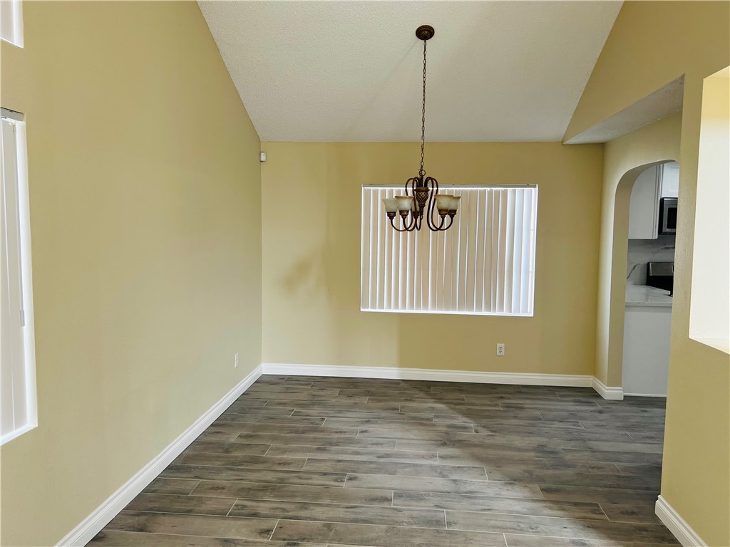 12771 Ponderosa Ranch Road Victorville, CA 92392 - Photo 9 of 23 a view of an empty room with window and wooden floor