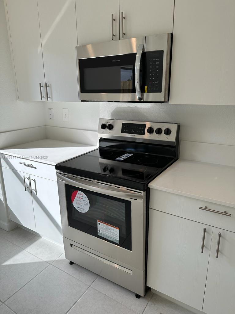 11926 Southwest 245 Terrace Homestead, FL 33032 - Photo 18 of 43 a stove top oven sitting inside of a kitchen