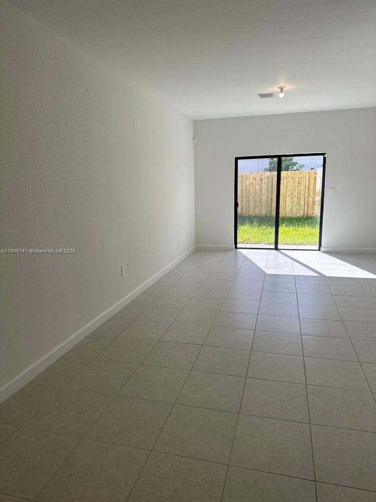 11926 Southwest 245 Terrace Homestead, FL 33032 - Photo 24 of 43 a view of an empty room with a window