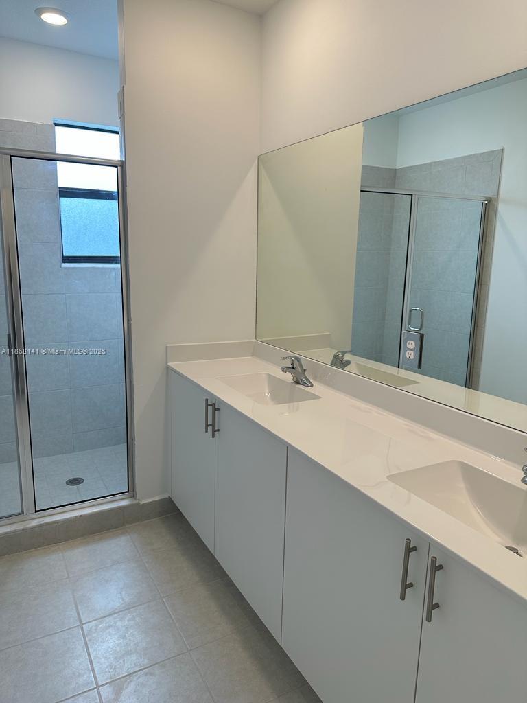 11926 Southwest 245 Terrace Homestead, FL 33032 - Photo 36 of 43 a bathroom with a sink and a mirror