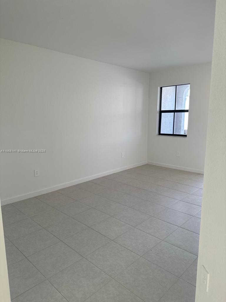 11926 Southwest 245 Terrace Homestead, FL 33032 - Photo 6 of 43 an empty room with a window