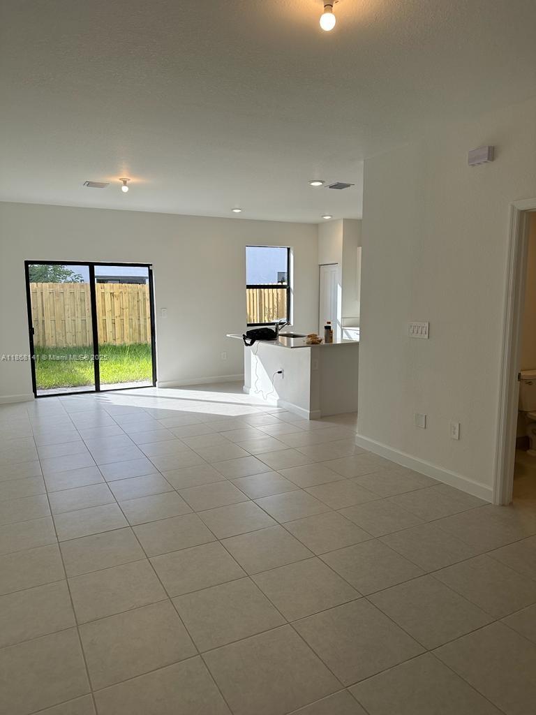 11926 Southwest 245 Terrace Homestead, FL 33032 - Photo 8 of 43 a view of a kitchen with furniture and a window