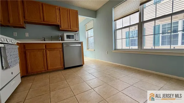 a kitchen with stainless steel appliances granite countertop a stove a refrigerator and a sink