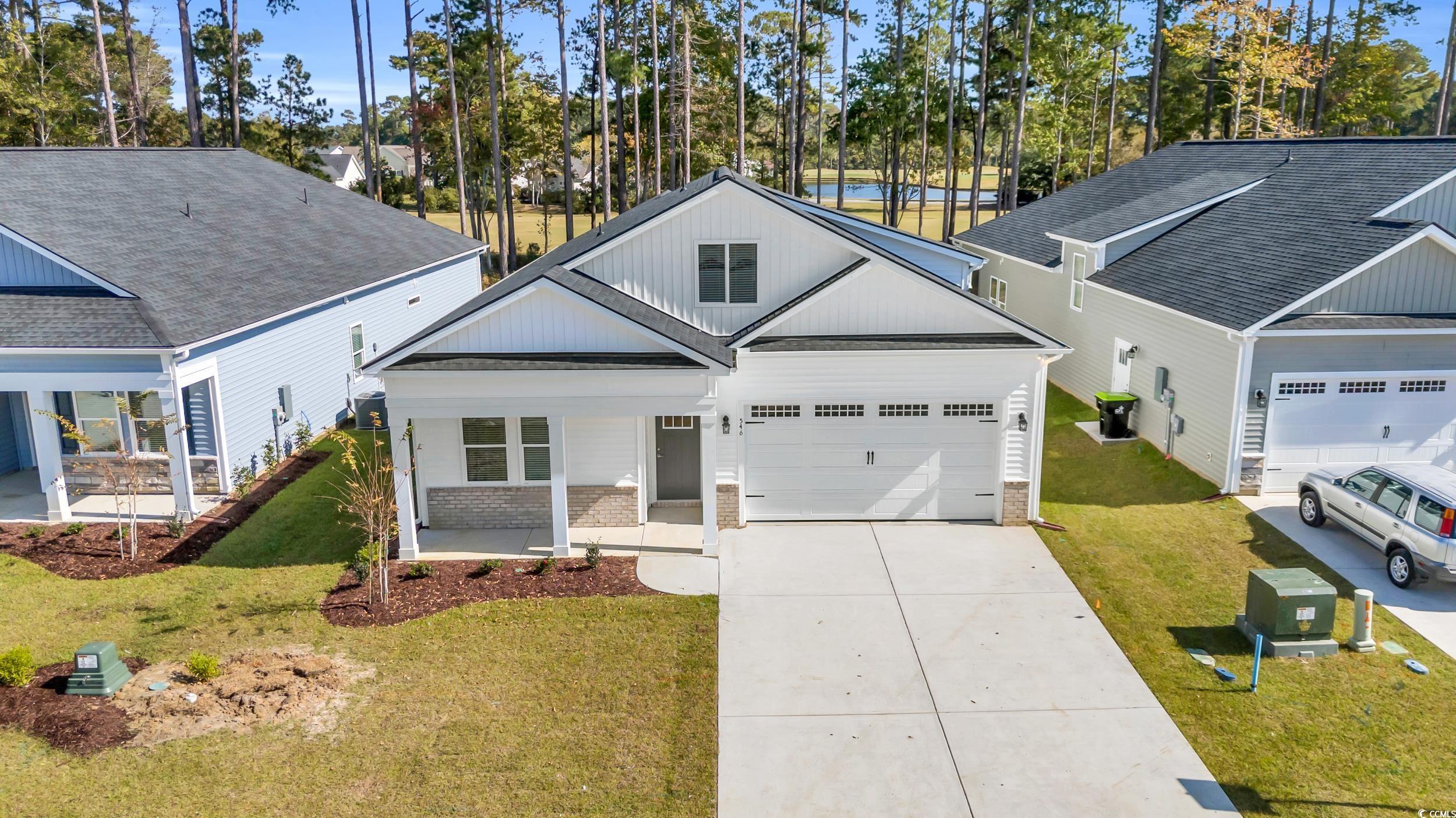 View of front of property with a garage, a porch,