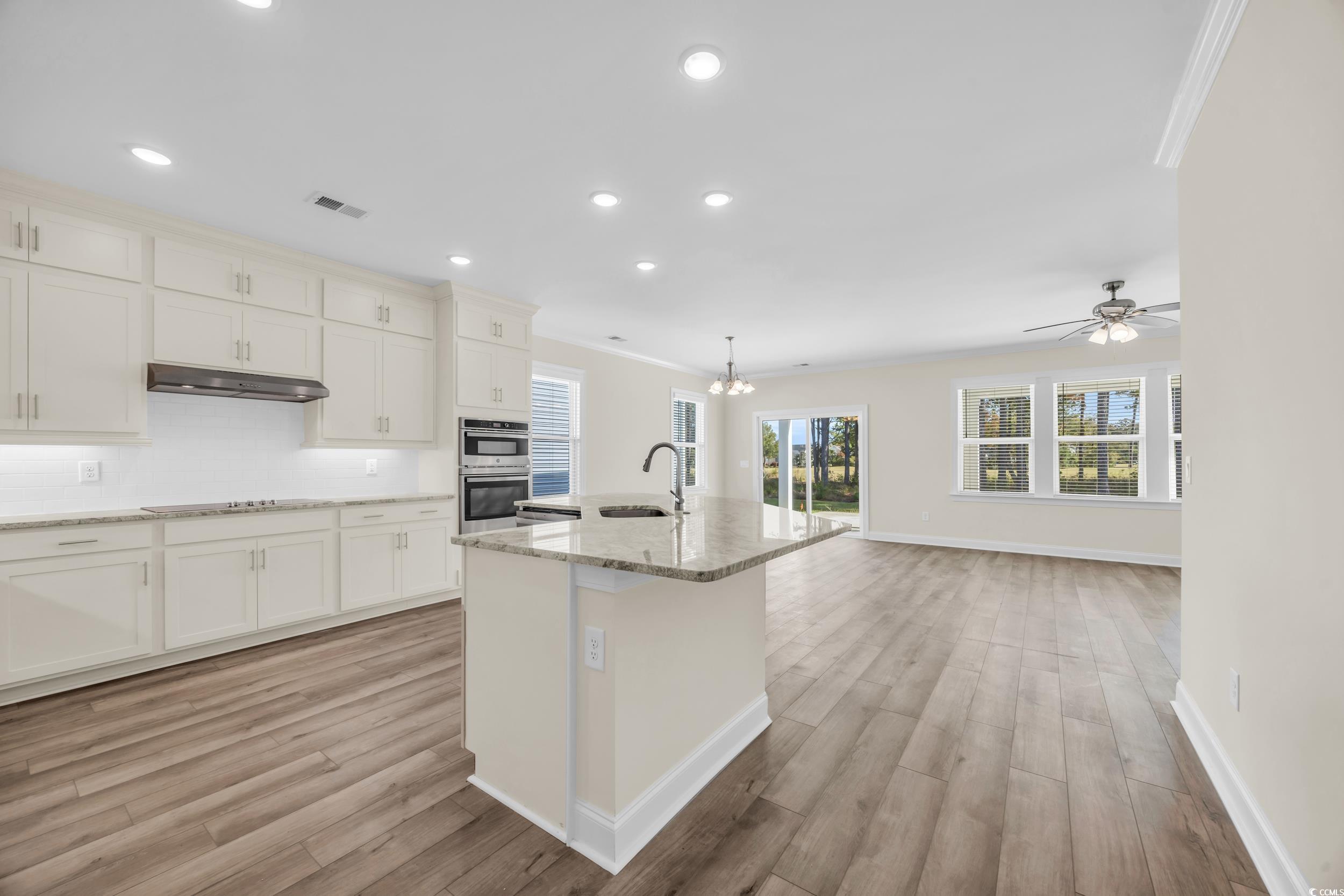 546 Beckham Court Murrells Inlet, SC 29576 - Photo 15 of 34 Kitchen featuring white cabinetry, sink, a kitchen