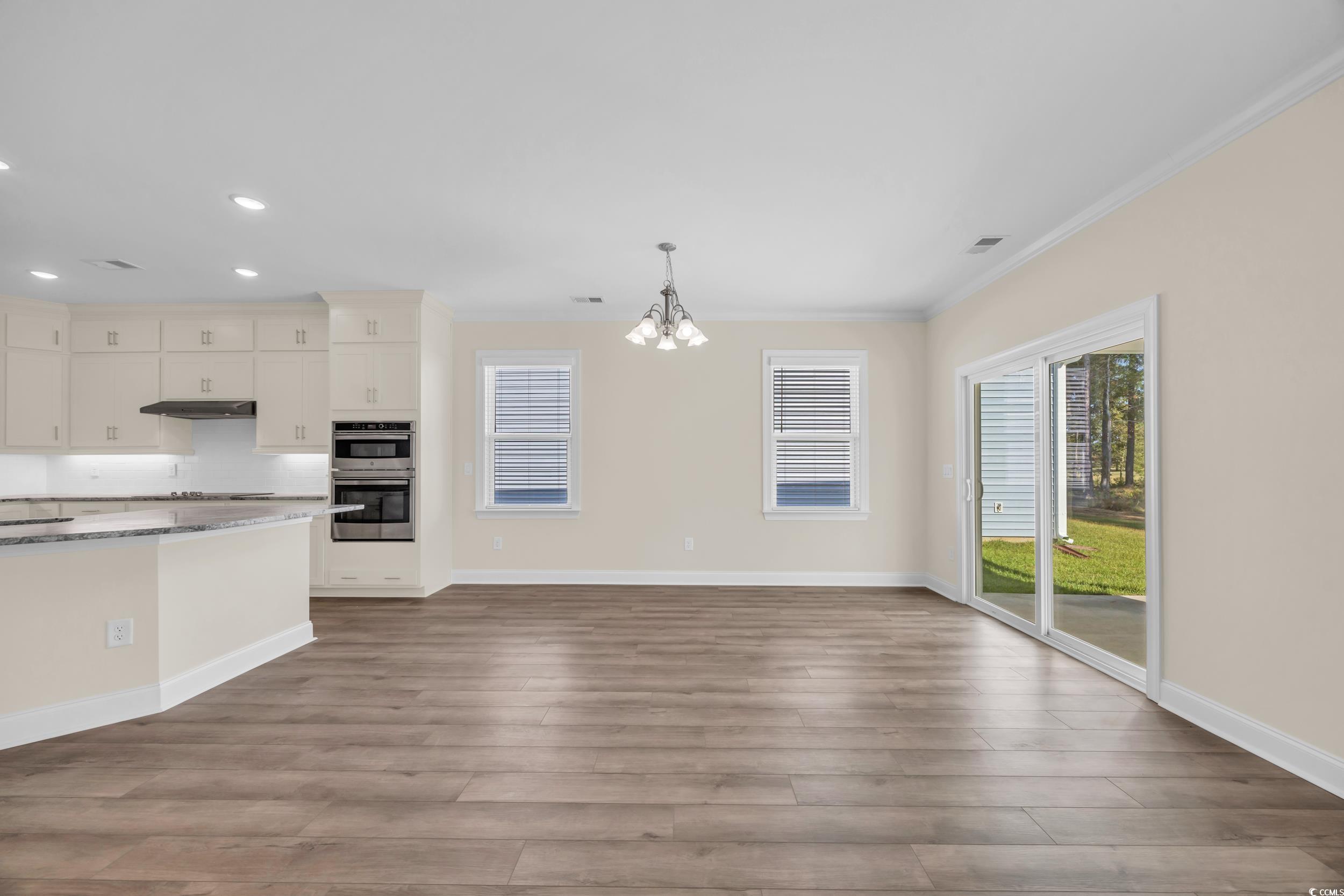 546 Beckham Court Murrells Inlet, SC 29576 - Photo 17 of 34 Kitchen with pendant lighting, crown molding, ligh