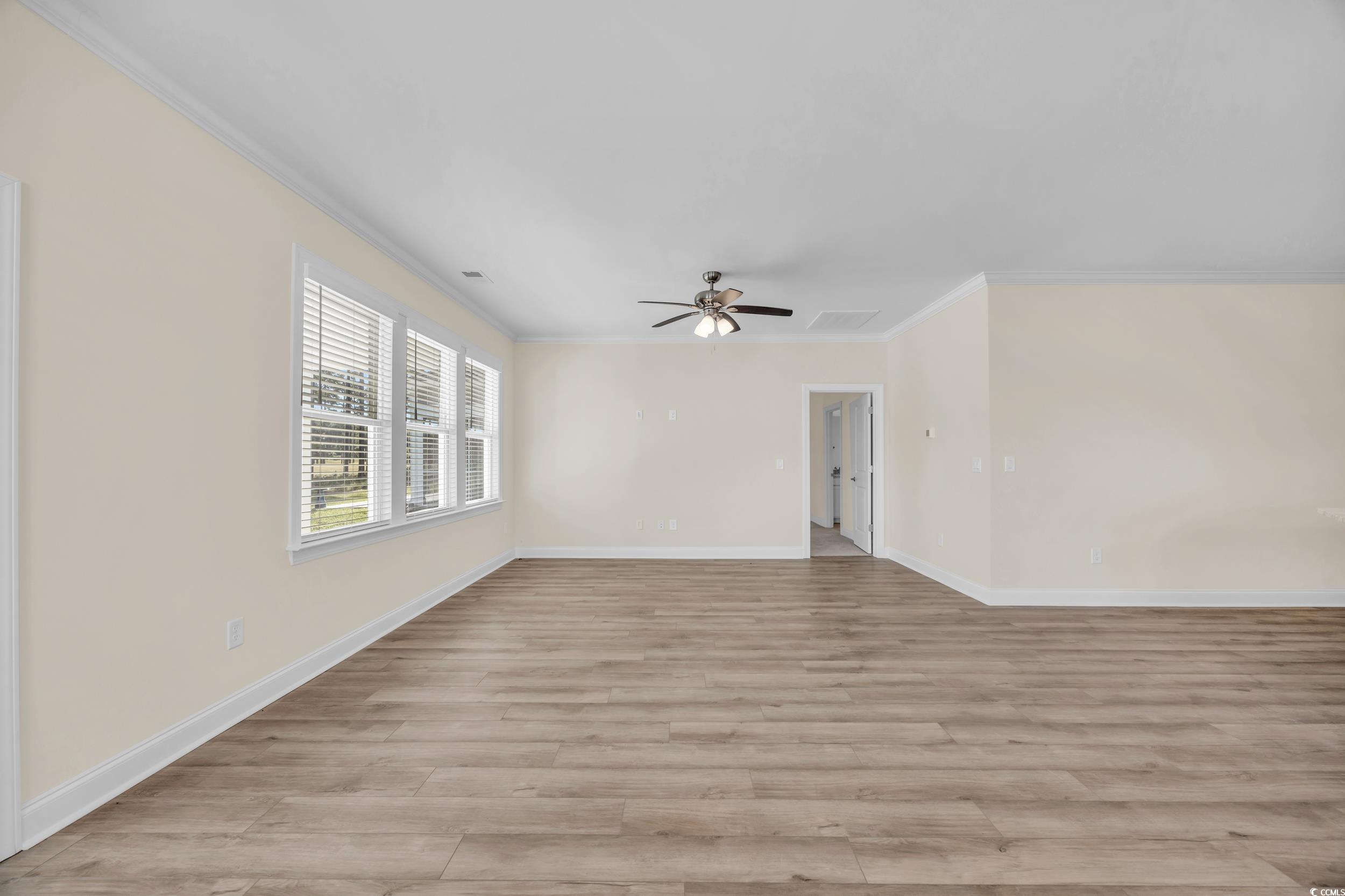 546 Beckham Court Murrells Inlet, SC 29576 - Photo 18 of 34 Empty room with ceiling fan, ornamental molding, a