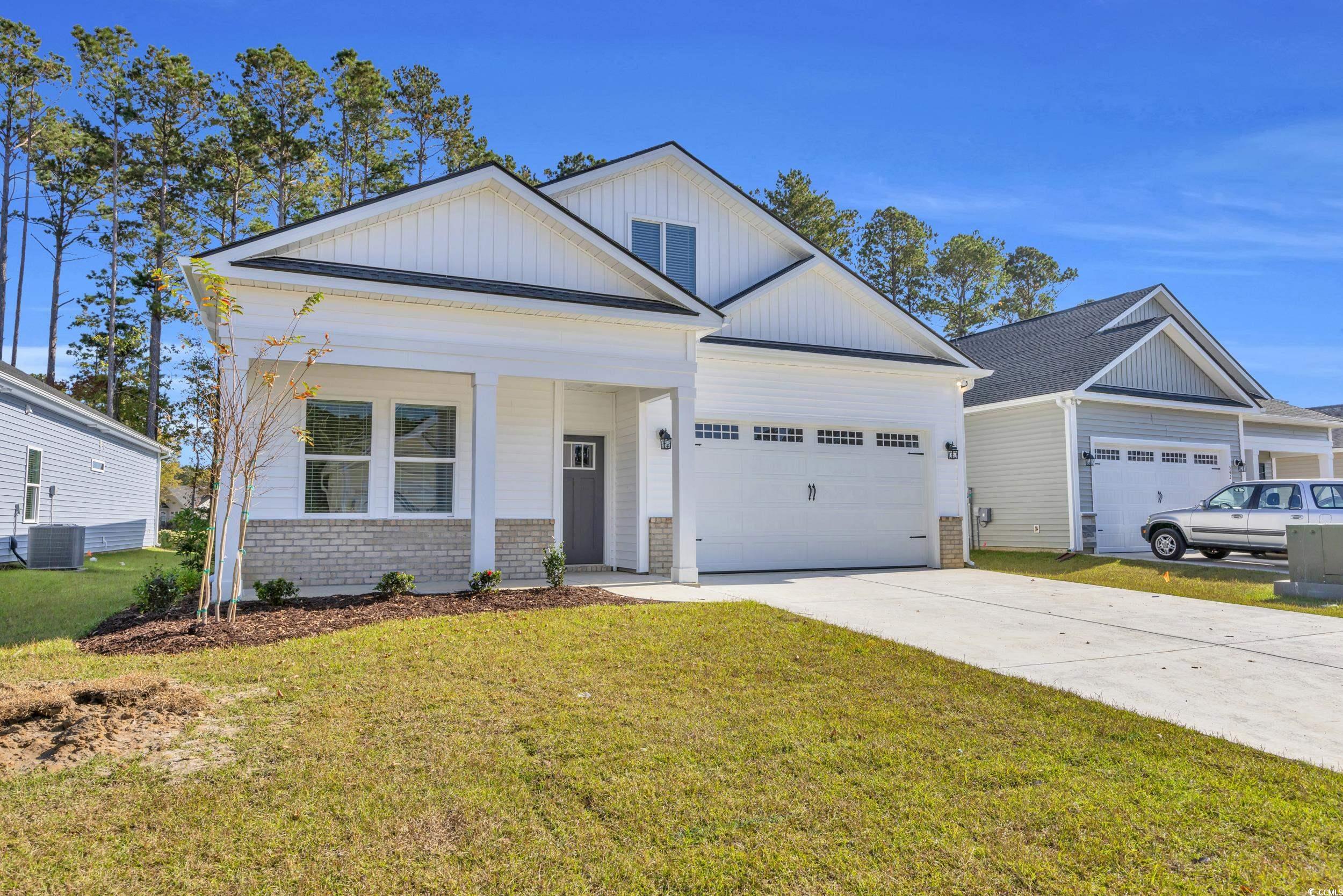 546 Beckham Court Murrells Inlet, SC 29576 - Photo 3 of 34 View of front facade featuring a garage, a front y