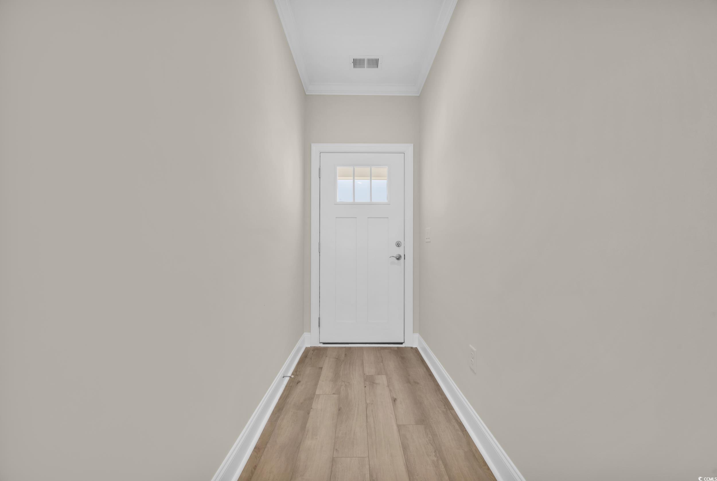 546 Beckham Court Murrells Inlet, SC 29576 - Photo 8 of 34 Entryway with ornamental molding and light hardwoo