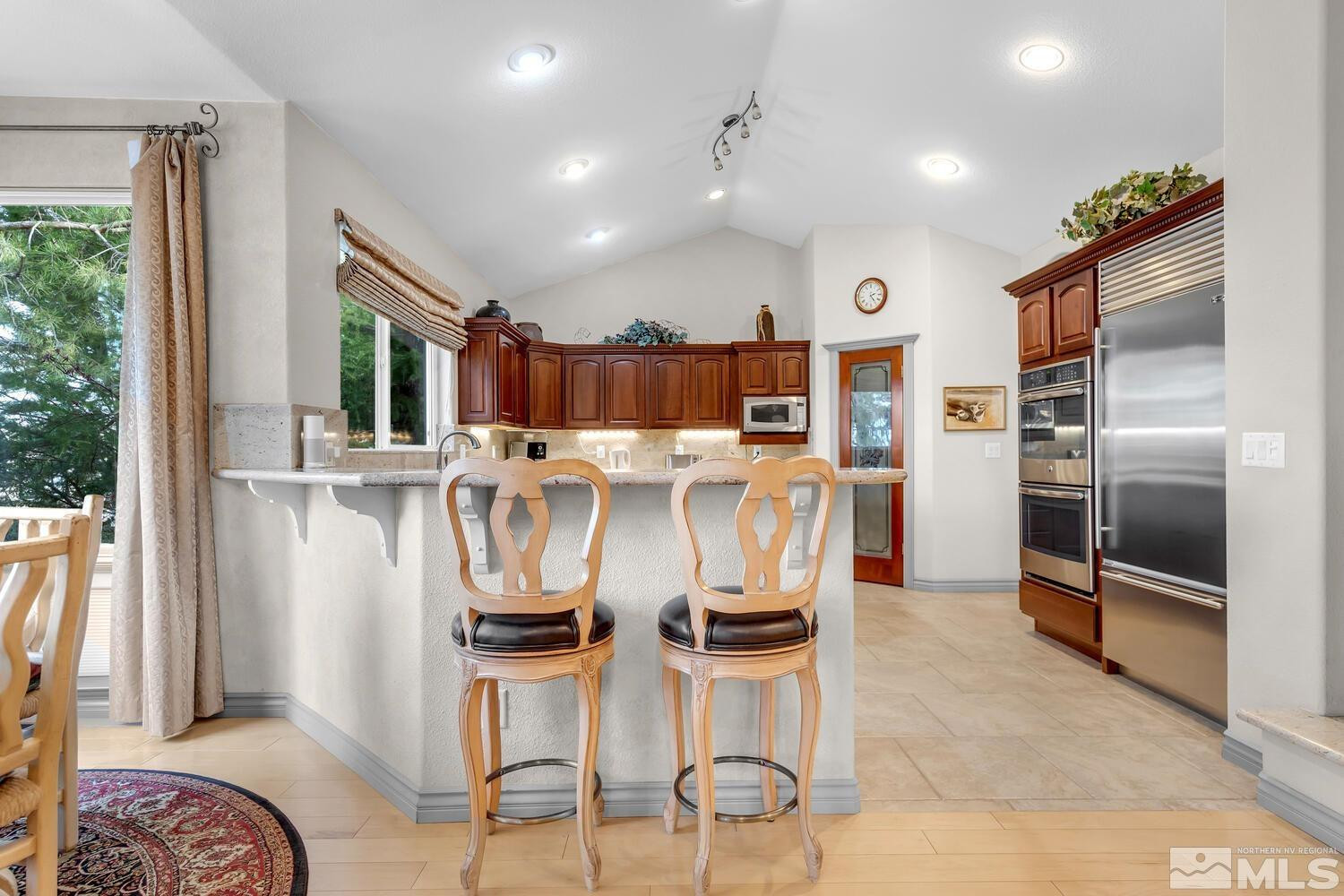 1465 Wolf Run Road Reno, NV 89511 - Photo 12 of 40 a kitchen with stainless steel appliances granite countertop a refrigerator and a sink