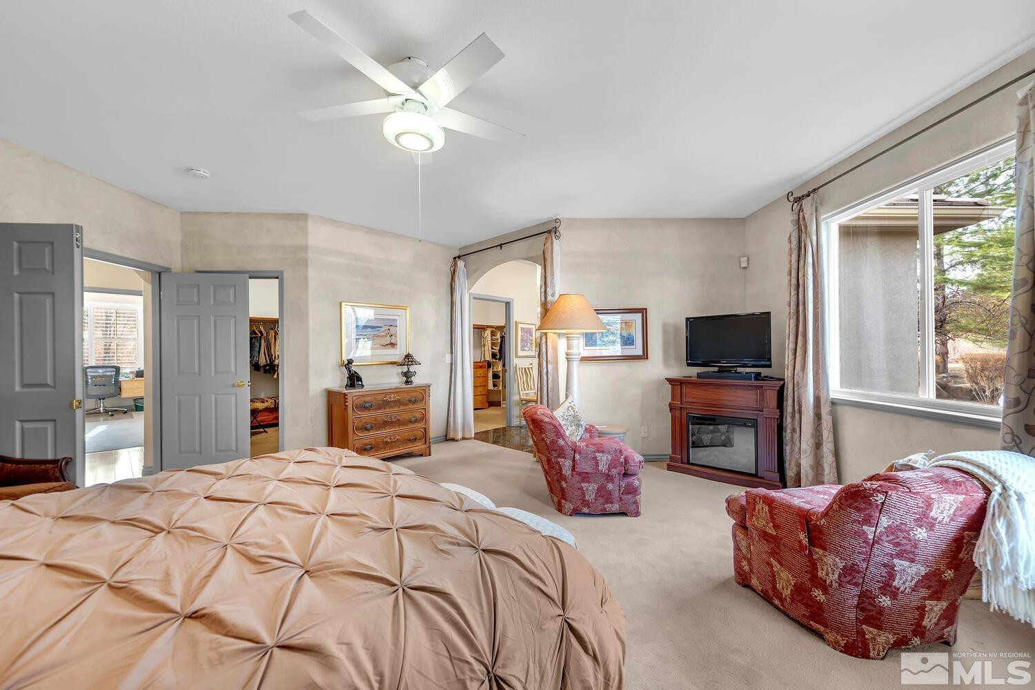 1465 Wolf Run Road Reno, NV 89511 - Photo 21 of 40 a bedroom with a bed a couch and dresser