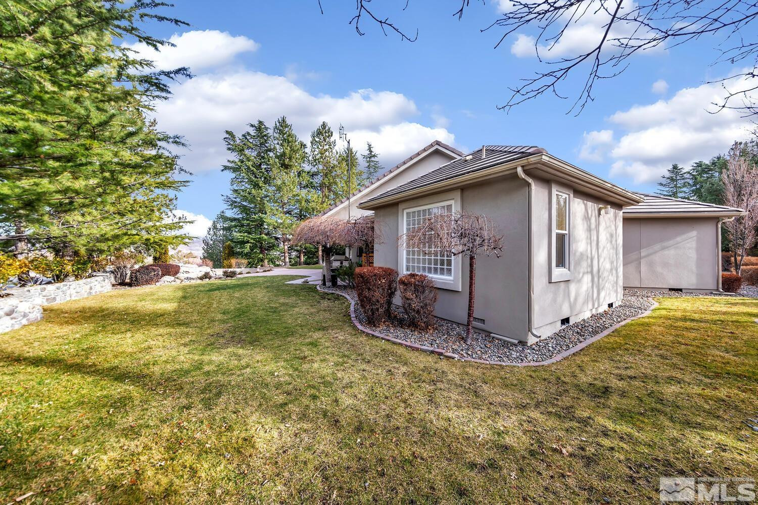 1465 Wolf Run Road Reno, NV 89511 - Photo 36 of 40 a view of a wooden house with a yard