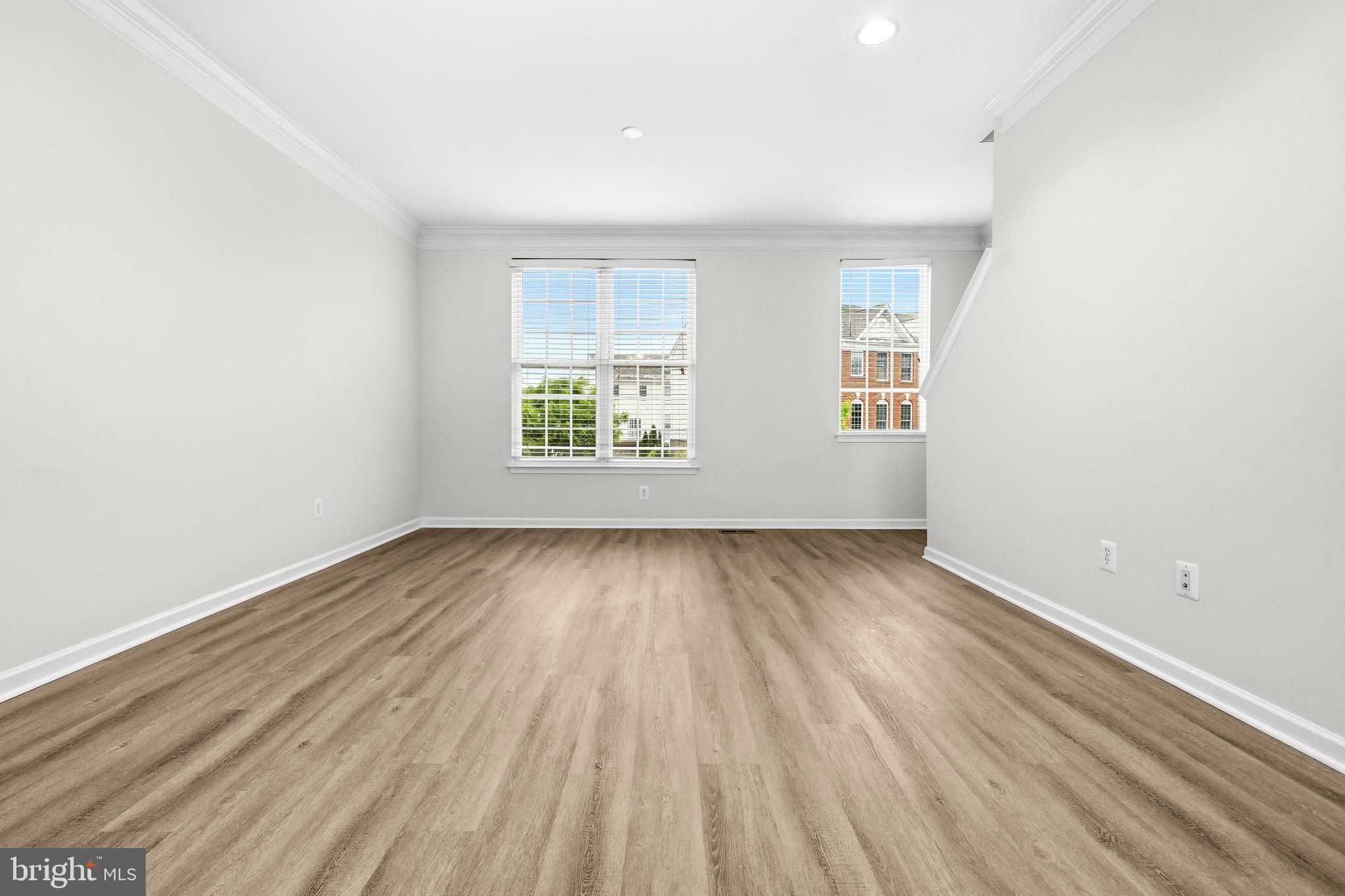25154 Monteith Terrace Chantilly, VA 20152 - Photo 4 of 40 an empty room with wooden floor and windows