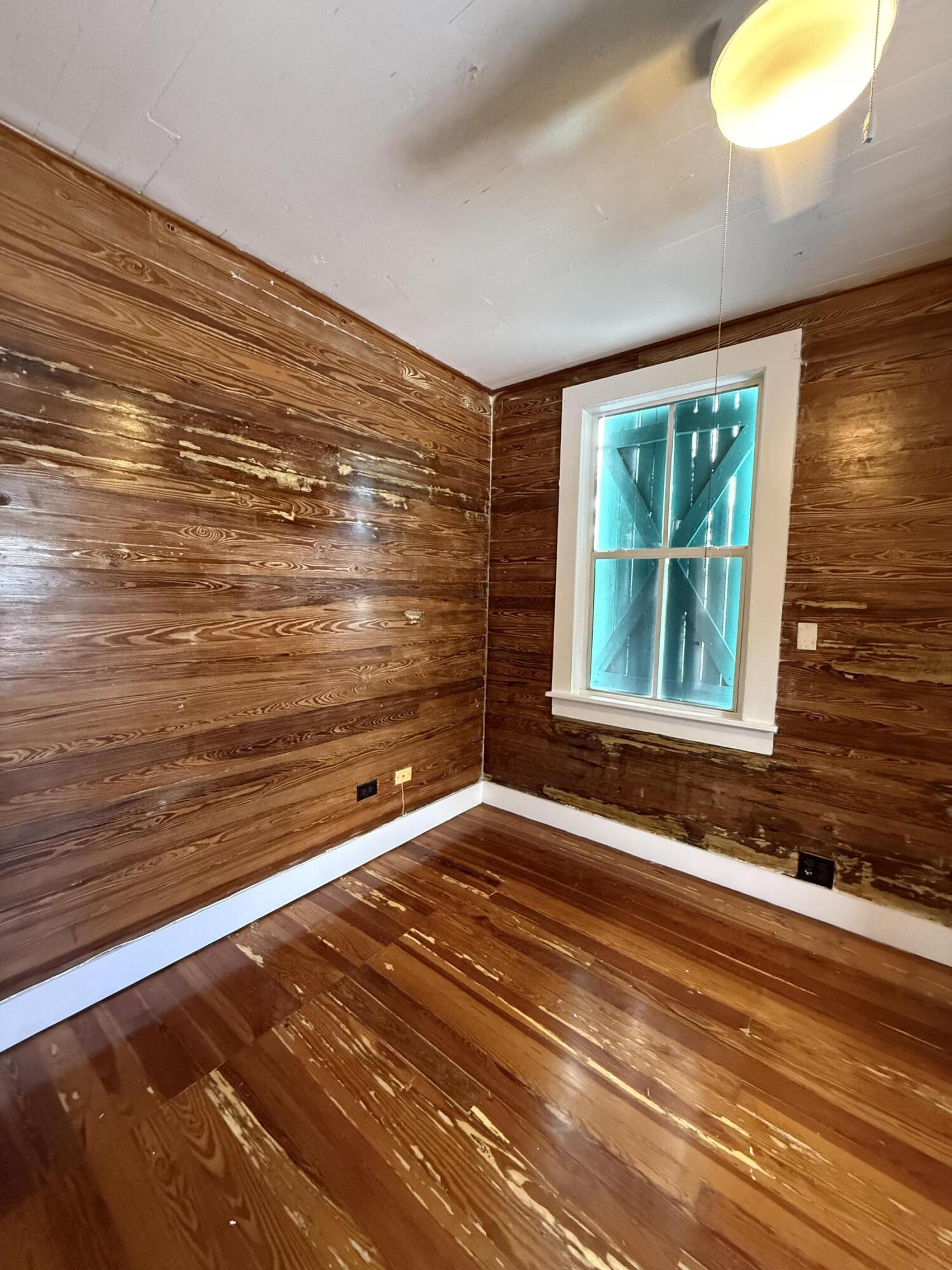 530 White Street Key West, FL 33040 - Photo 67 of 69 a view of an empty room with a window and wooden floor