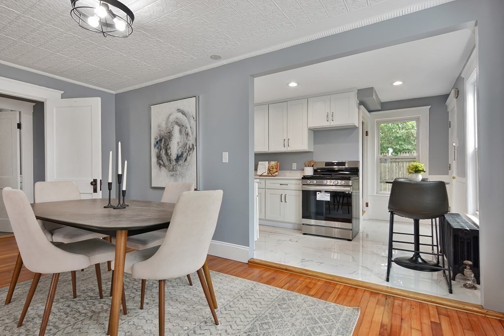 47 Moore Street Lowell, MA 01852 - Photo 11 of 36 a view of a dining room with furniture and wooden floor