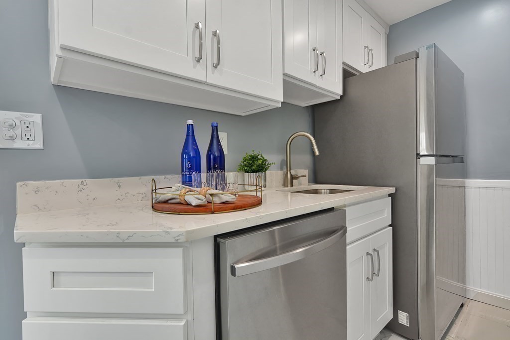 47 Moore Street Lowell, MA 01852 - Photo 13 of 36 a kitchen with stainless steel appliances a sink a stove and refrigerator
